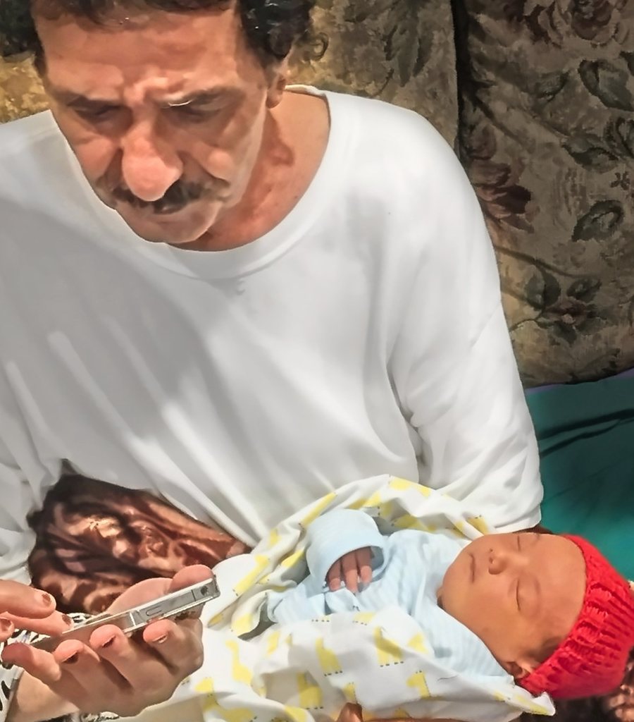 Joe holding a newborn